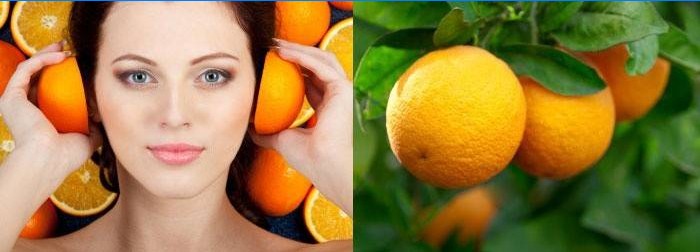 Kvinnan rymmer apelsiner