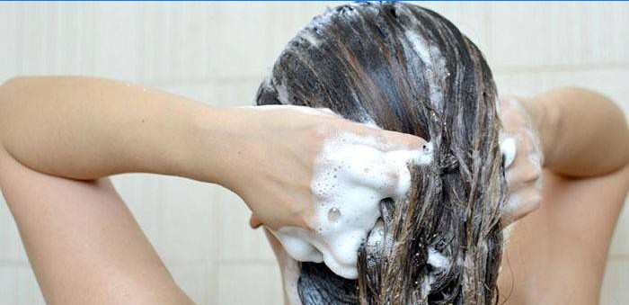 Flickan tvättar huvudet