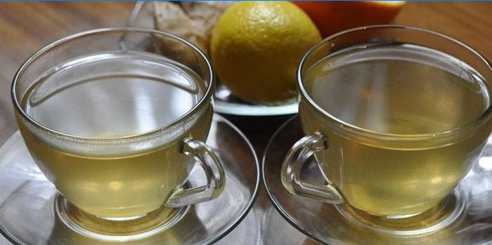 Två koppar grönt te med ingefära och apelsin.